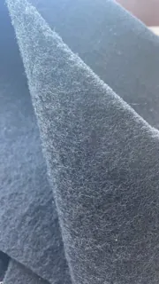 Close-up of the fibrous texture of PET polyester-based carbon filter media