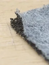 Sandwich nonwoven sample showing spherical carbon between fibrous layers